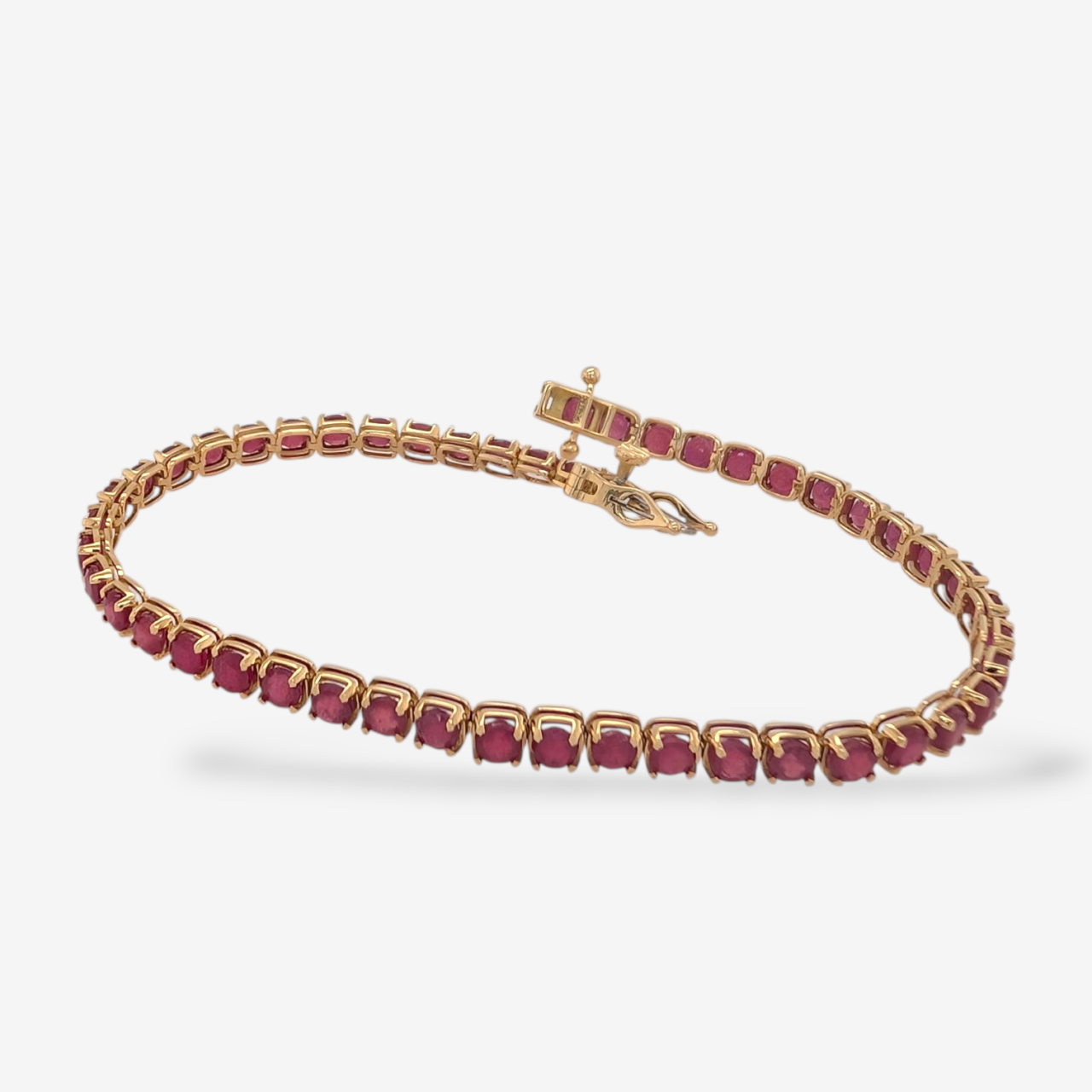 Brazalete (18 cm) Tennis c/ Rubíes Ovalados (9.20 Ct) 4 Prongs (3.7 mm) c/ Dos Aros de Seguridad - Oro Amarillo 18Kts